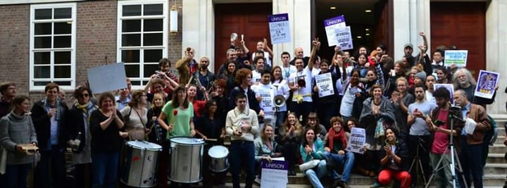 Cleaners protest on the steps for improved conditions